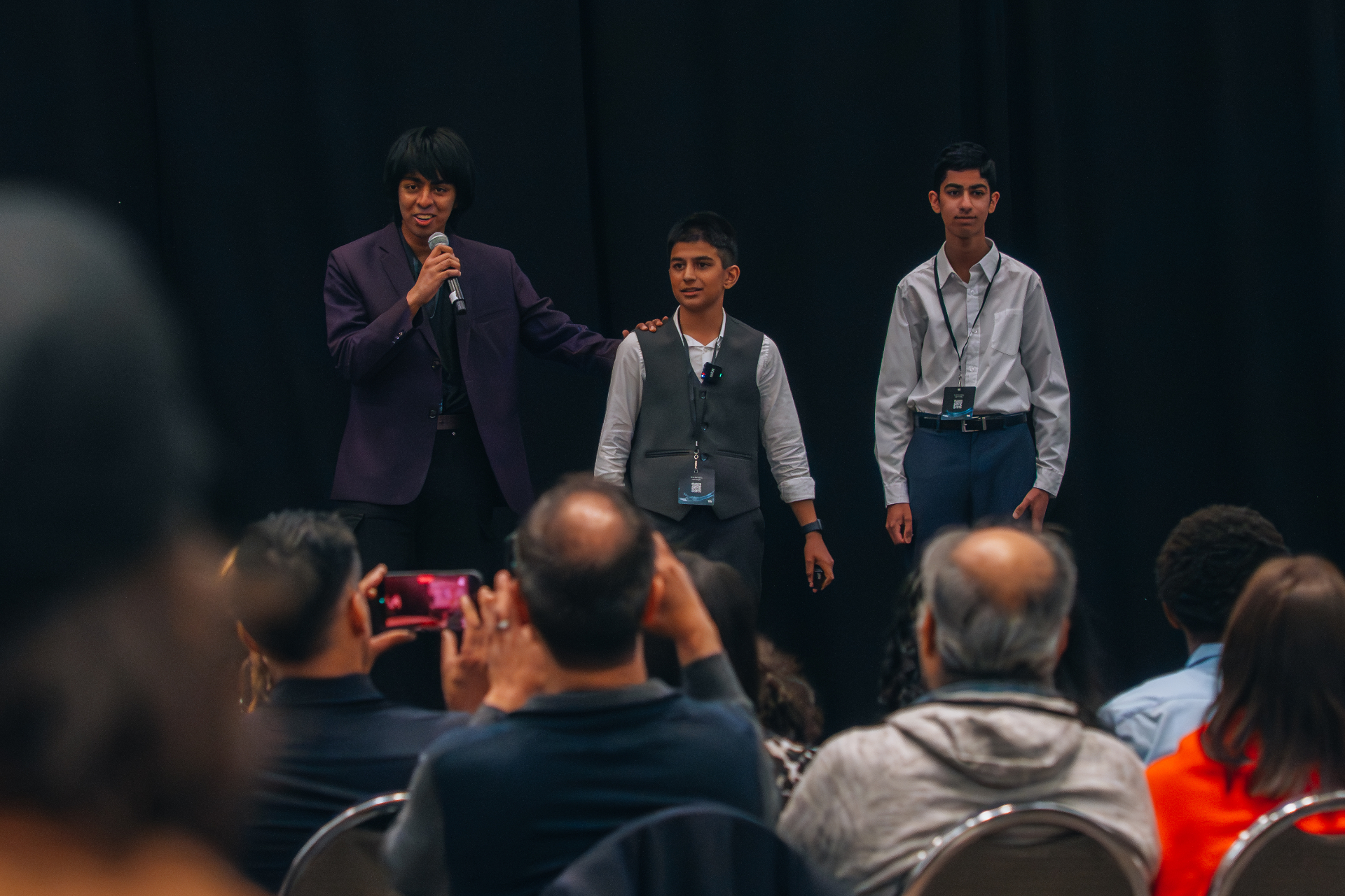 Rafan Hasan speaking on stage to an audience